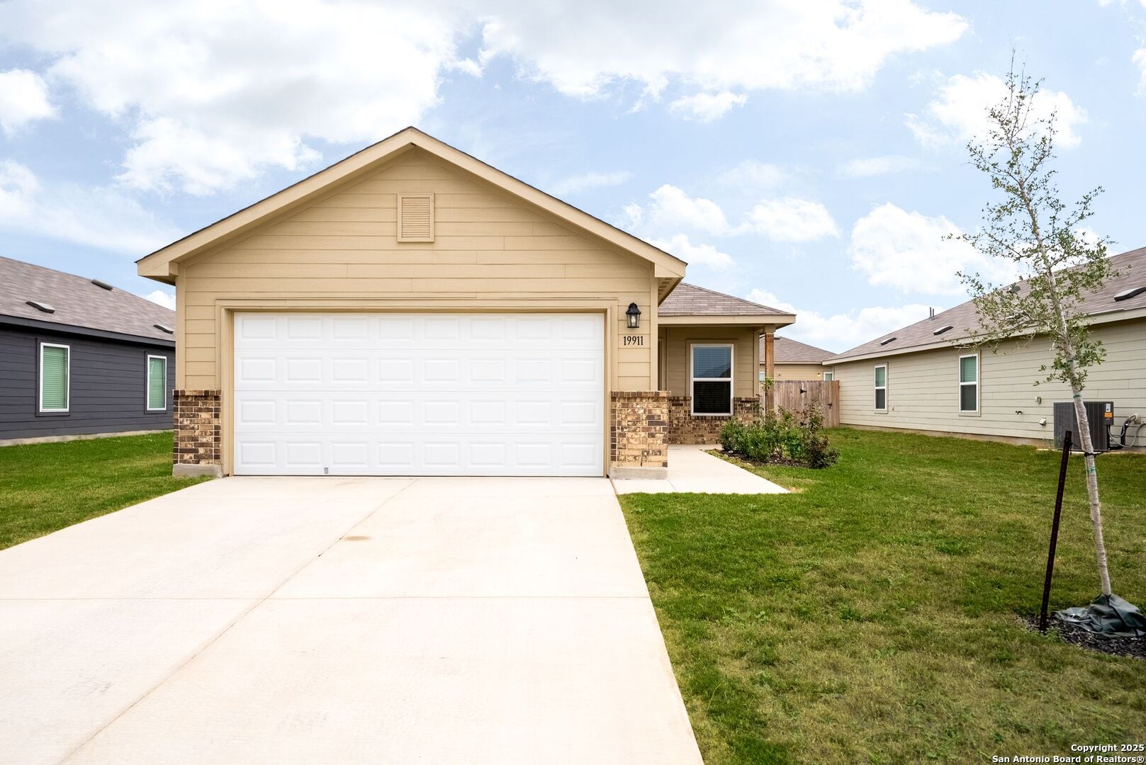 19911 Wyatt Earp Way Lytle, TX 78052 - Photo 1 of 26 a front view of house with yard and green space