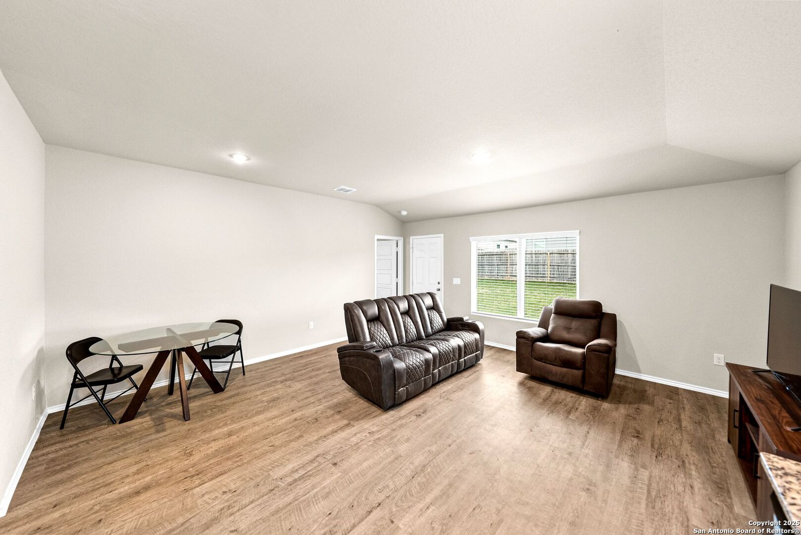 19911 Wyatt Earp Way Lytle, TX 78052 - Photo 12 of 26 a living room with furniture and a wooden floor