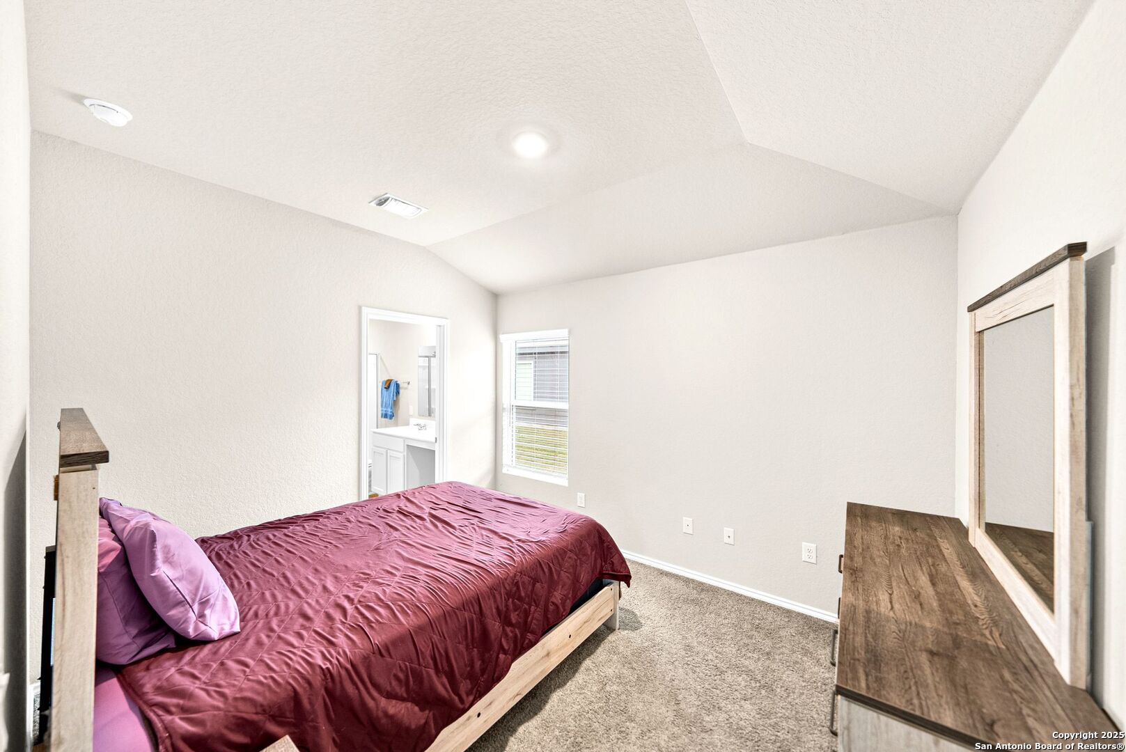 19911 Wyatt Earp Way Lytle, TX 78052 - Photo 13 of 26 a bedroom with a large bed and a couch