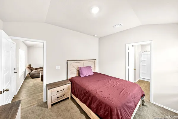 a bed room with a bed and a large mirror