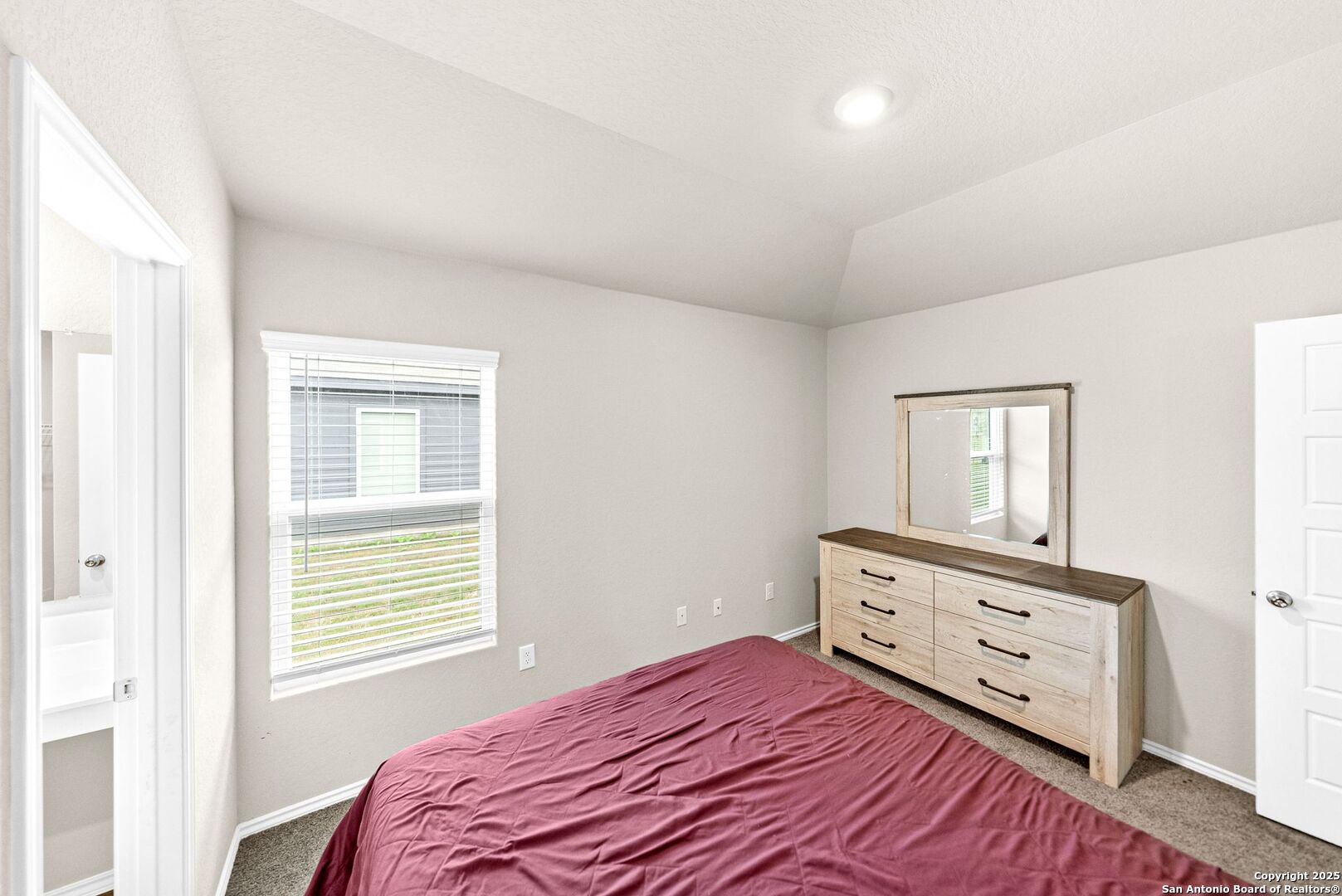 19911 Wyatt Earp Way Lytle, TX 78052 - Photo 15 of 26 a bedroom with a bed and a window