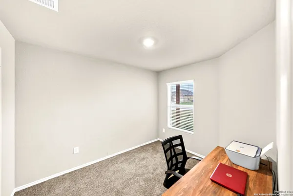 a view of a room with lounge chair and a window