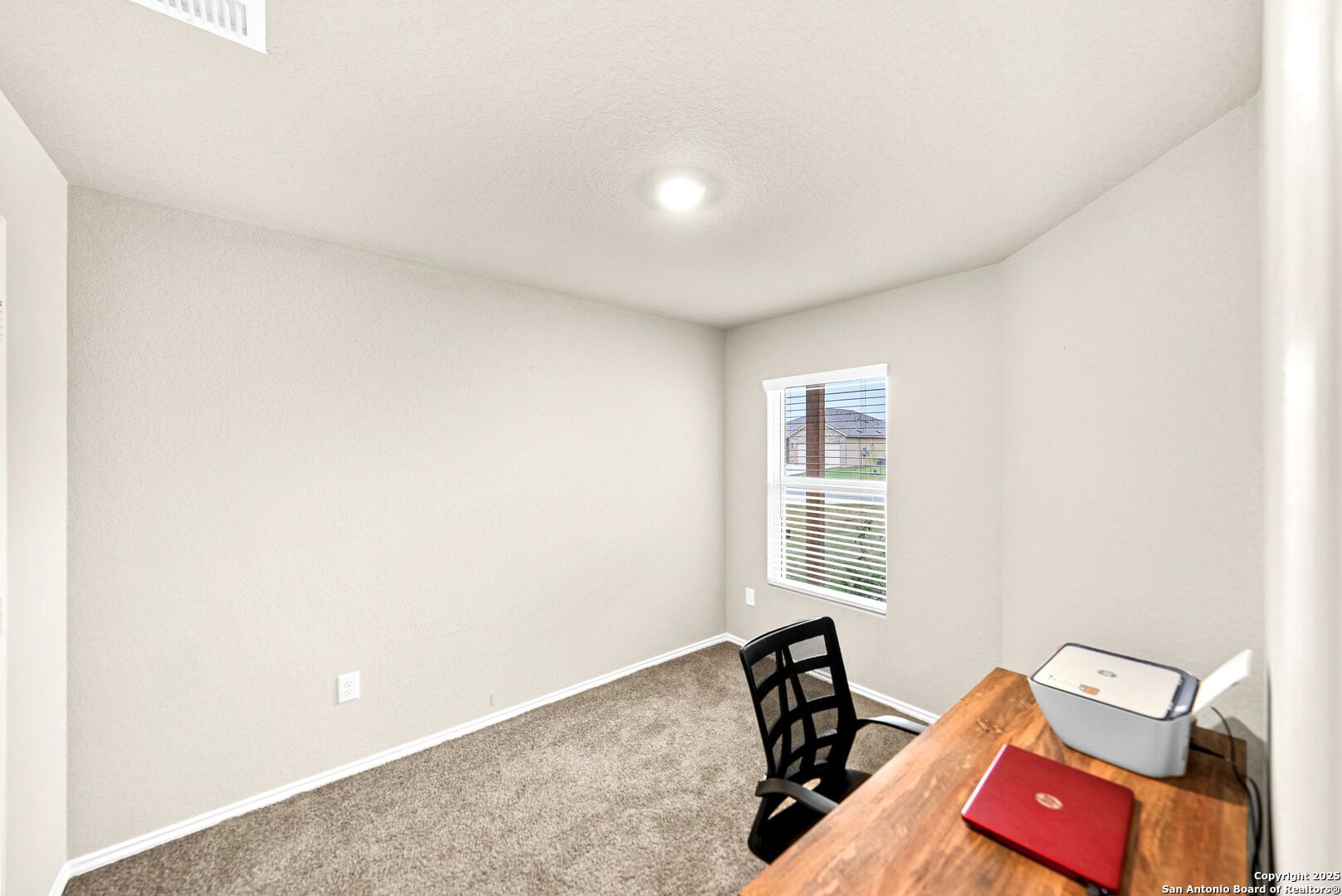 19911 Wyatt Earp Way Lytle, TX 78052 - Photo 20 of 26 a view of a room with lounge chair and a window