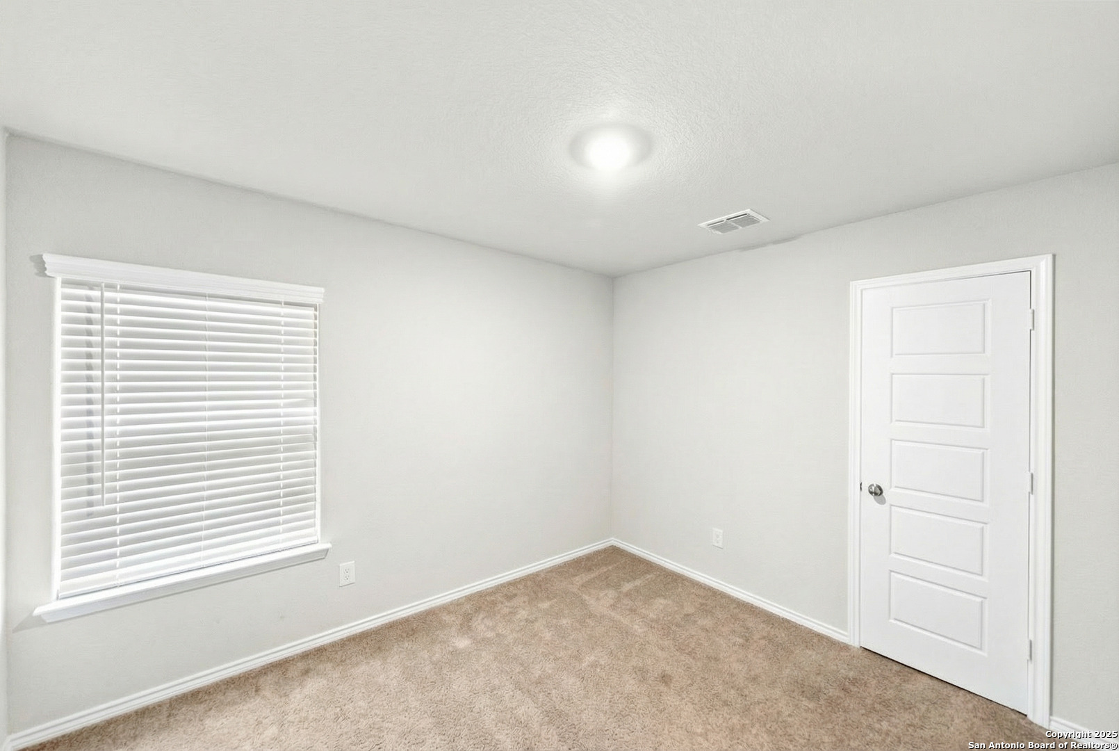 19911 Wyatt Earp Way Lytle, TX 78052 - Photo 22 of 26 an empty room with a window