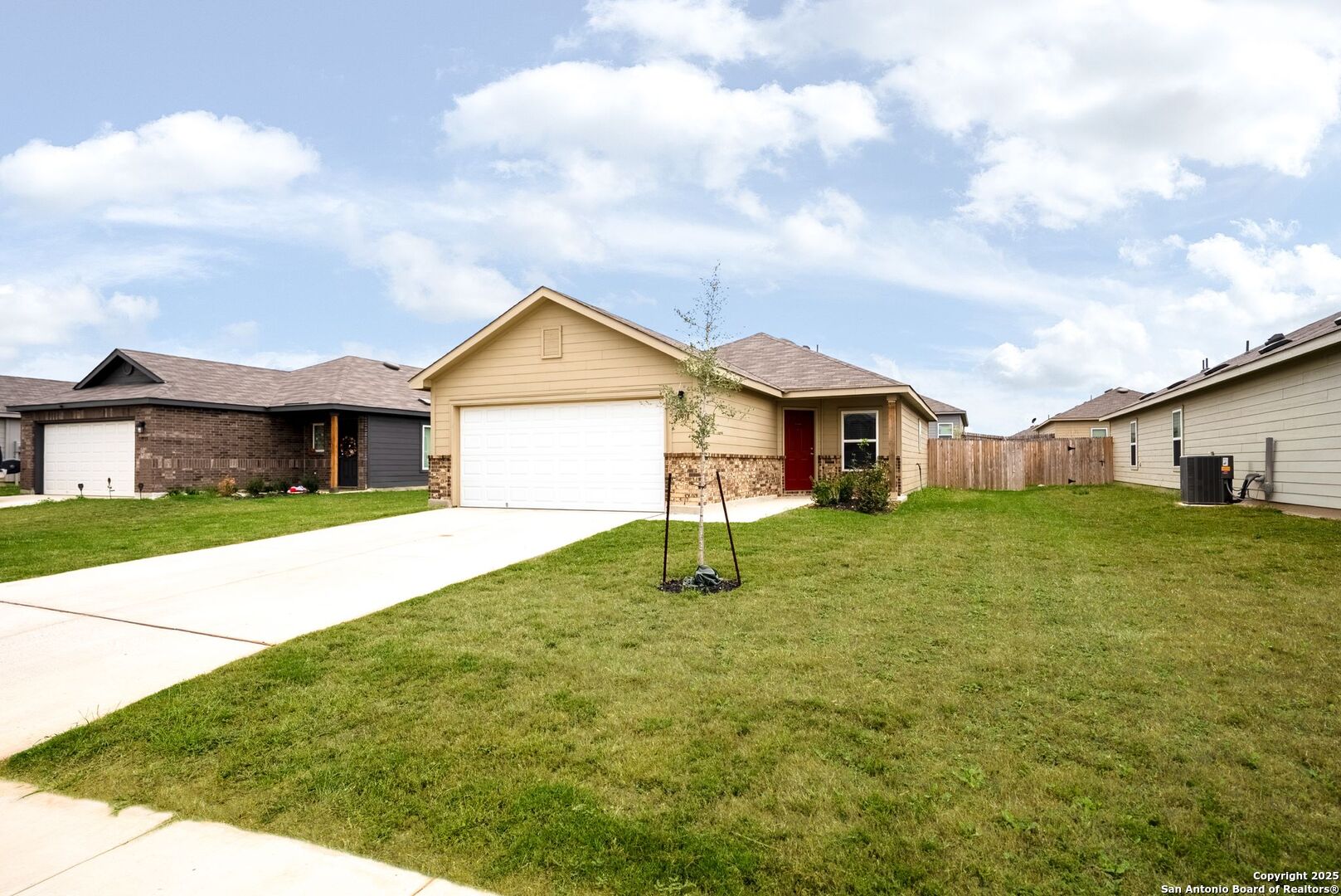 19911 Wyatt Earp Way Lytle, TX 78052 - Photo 3 of 26 a house view with a garden space