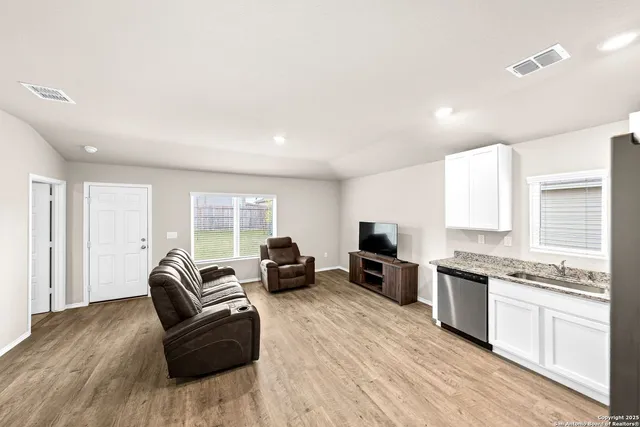 a living room with furniture window and wooden floor