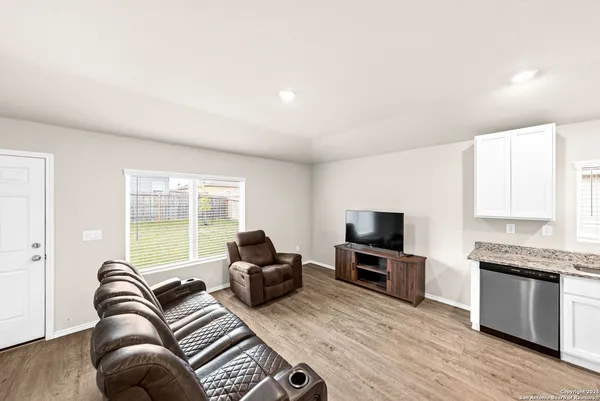 a living room with furniture fireplace and flat screen tv