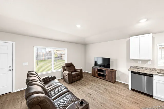 a living room with furniture fireplace and flat screen tv