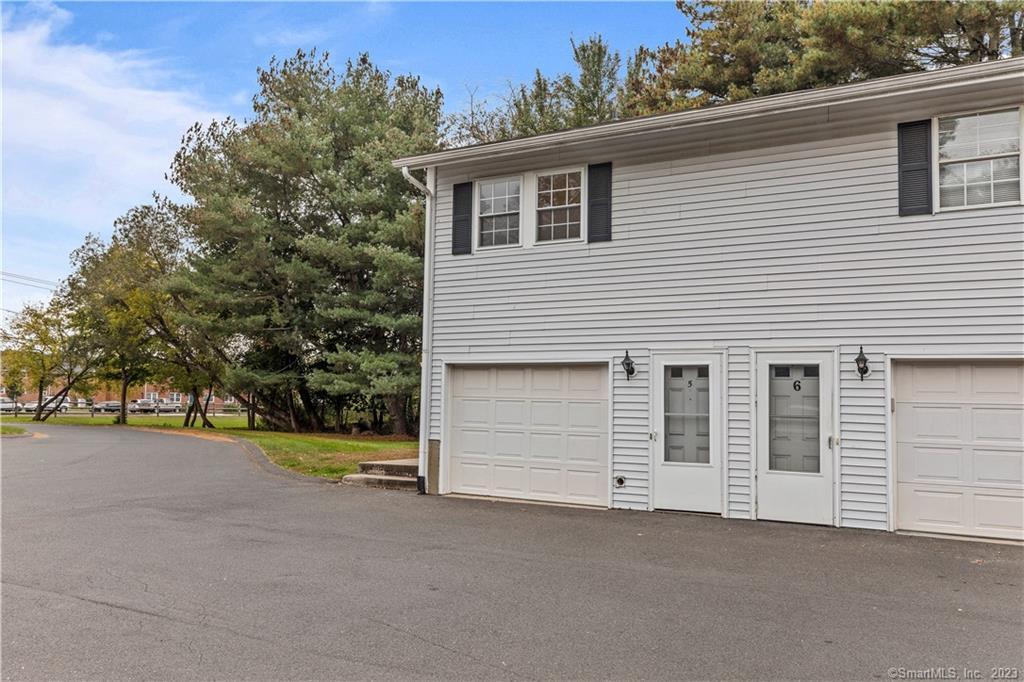 213 Regan Road, Unit 5 Vernon, CT 06066 - Photo 1 of 1 a view of a house with a yard and garage