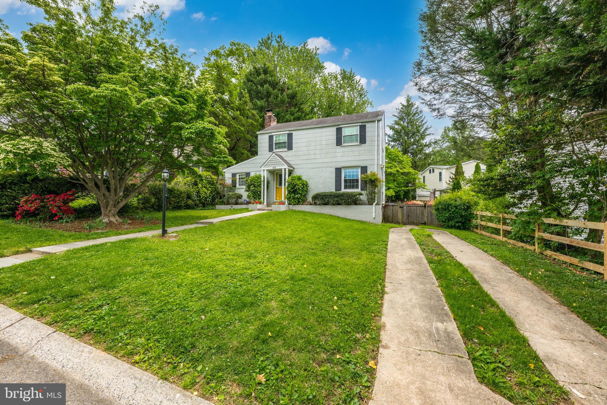 403 East Melbourne Avenue Silver Spring, MD 20901 - Photo 29 of 33 a view of a white house with a big yard plants and large trees