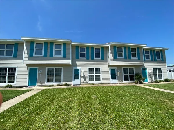 a front view of a building with a garden