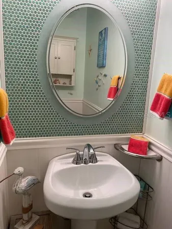 a bathroom with a sink and mirror