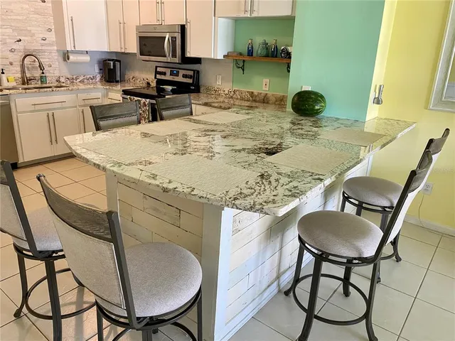 a kitchen with a table chairs and a sink