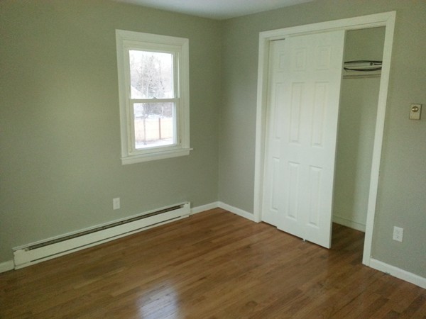 70 Starling Road Springfield, MA 01119 - Photo 6 of 25 an empty room with wooden floor and windows