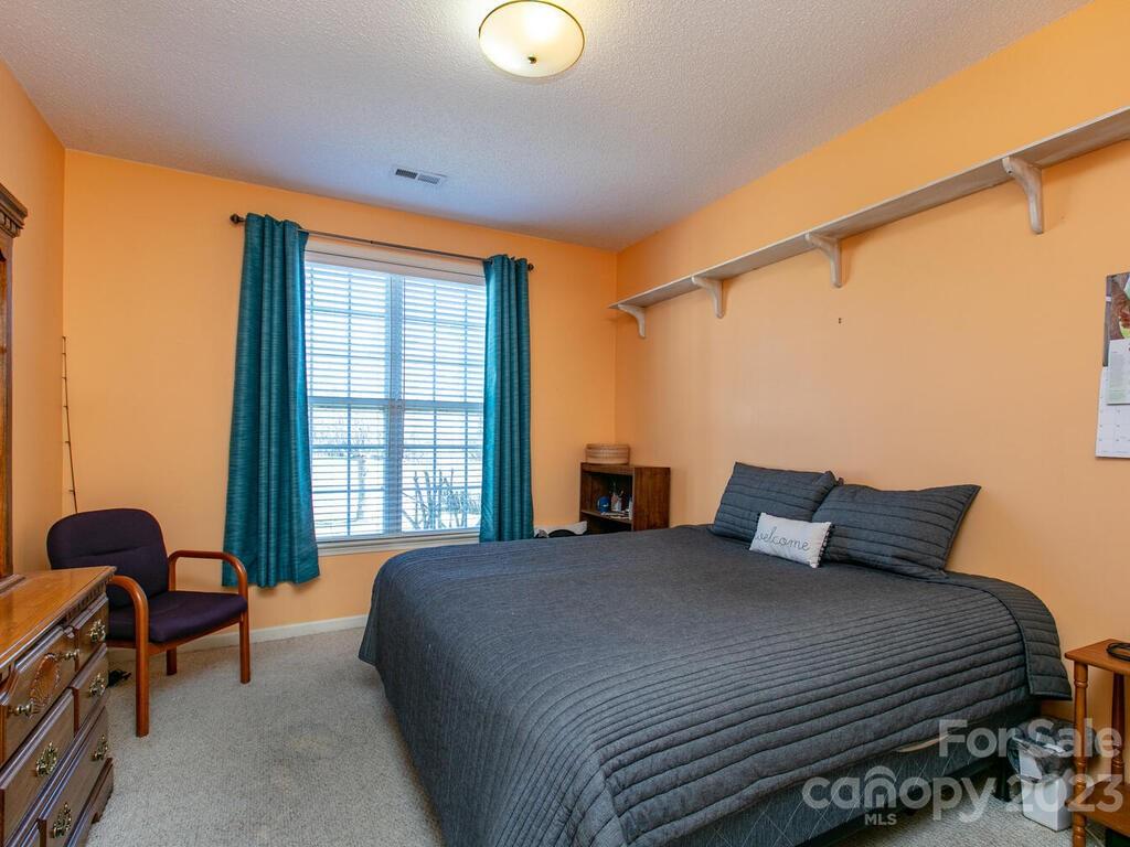 256 Walnut Crest Road Fletcher, NC 28732 - Photo 25 of 38 a bedroom with a bed and a window
