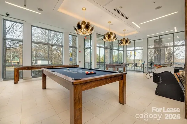 a living room with a table chairs and a large window