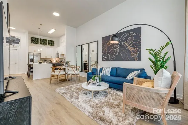a living room with furniture a rug and a painting