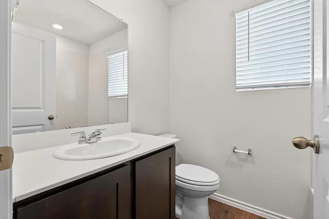 a bathroom with a sink a toilet and mirror