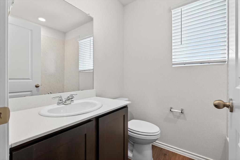 331 Clematis Street Princeton, TX 75407 - Photo 16 of 19 a bathroom with a sink a toilet and mirror