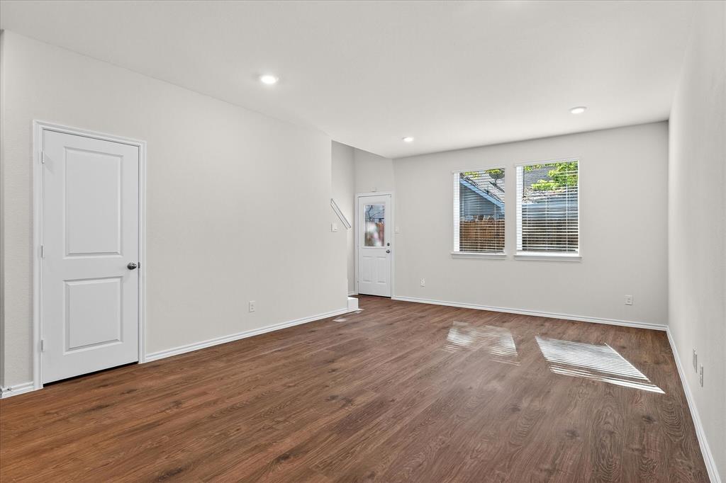 331 Clematis Street Princeton, TX 75407 - Photo 8 of 19 a view of an empty room with wooden floor and a window