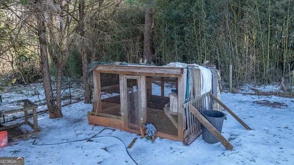 a view of a chairs and table in the backyard