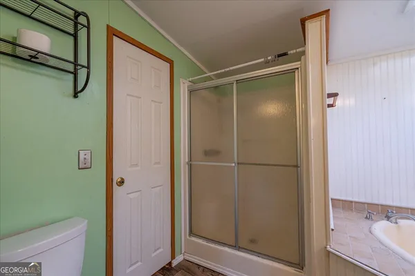 a bathroom with a shower and a sink