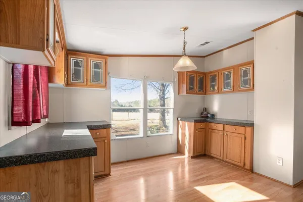a kitchen that has a stove and a wooden floors