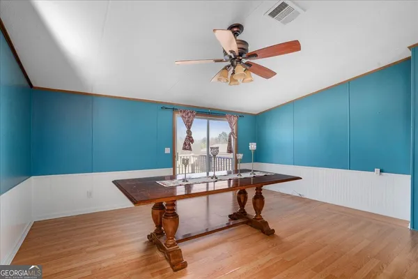 a view of a workspace with furniture and wooden floor
