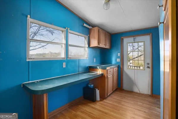 a room with kitchen island a wooden floor and a window