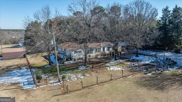 a view of a house with a yard and sitting area