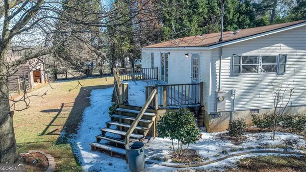 a view of a house with backyard and sitting area