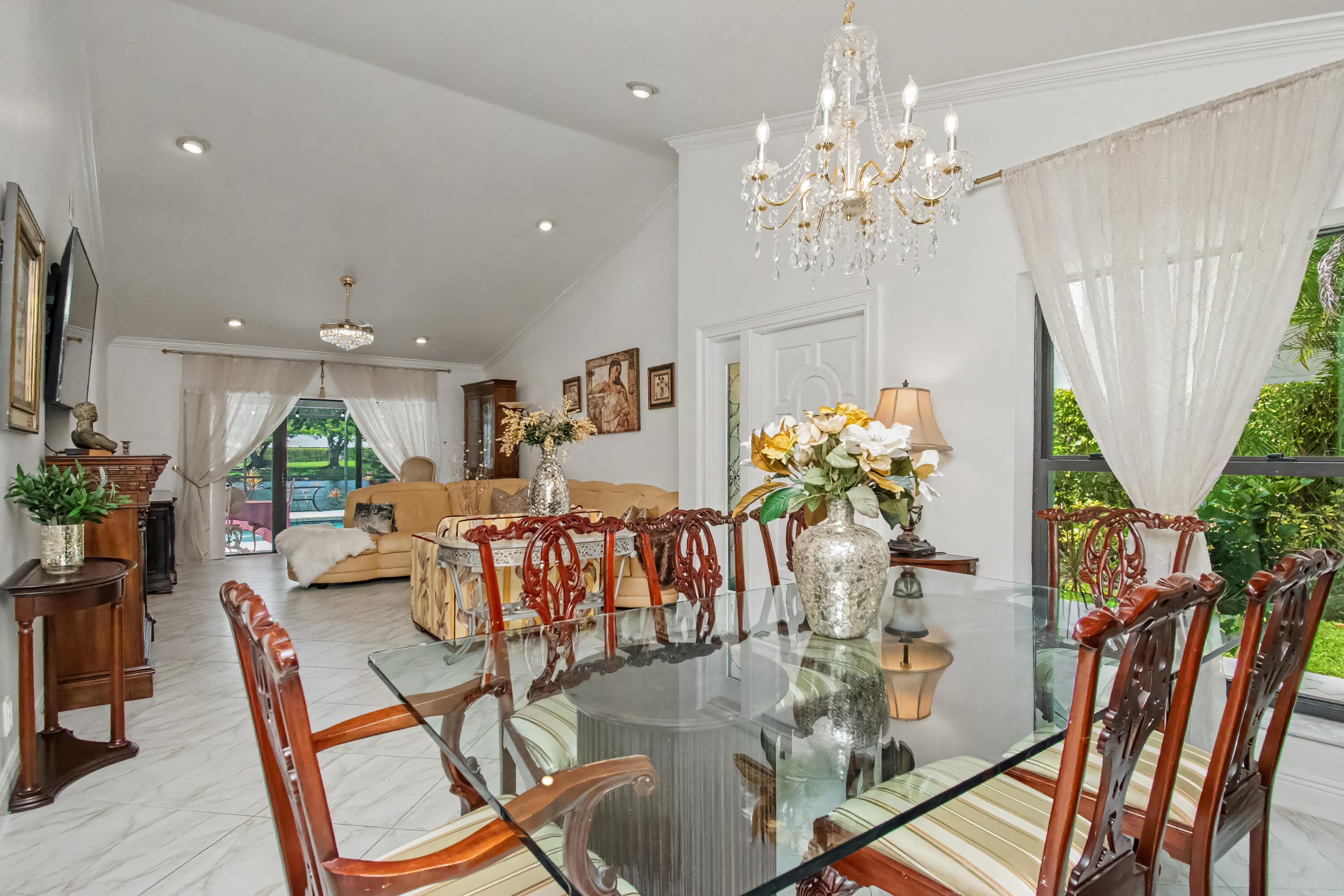 9708 Erica Court Boca Raton, FL 33496 - Photo 19 of 54 a view of a dining room with furniture a chandelier and wooden floor
