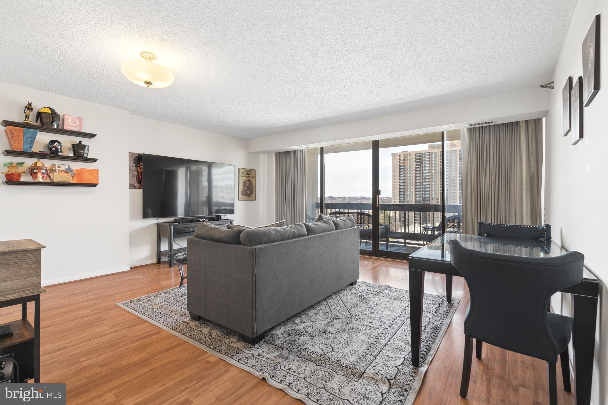 a living room with furniture and large windows