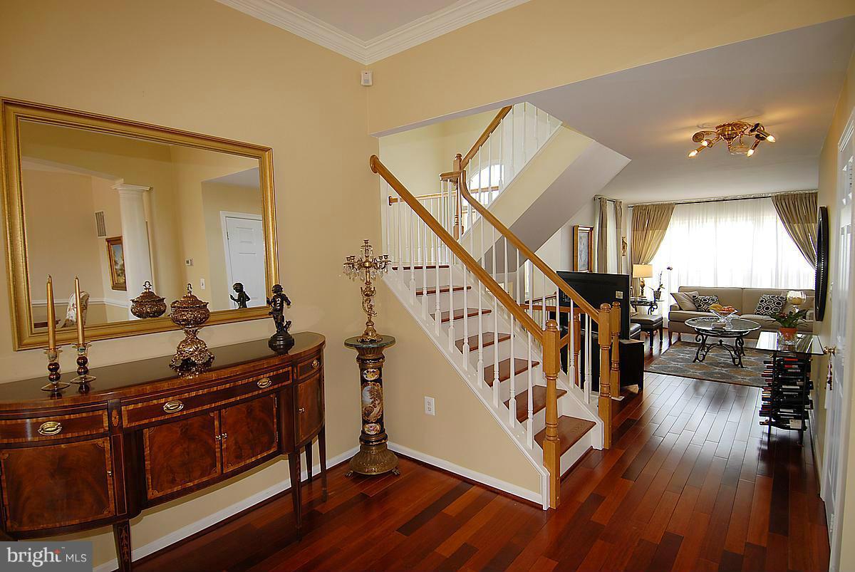 44047 Rising Sun Terrace Ashburn, VA 20147 - Photo 17 of 30 a view of front door with hallway and wooden floor