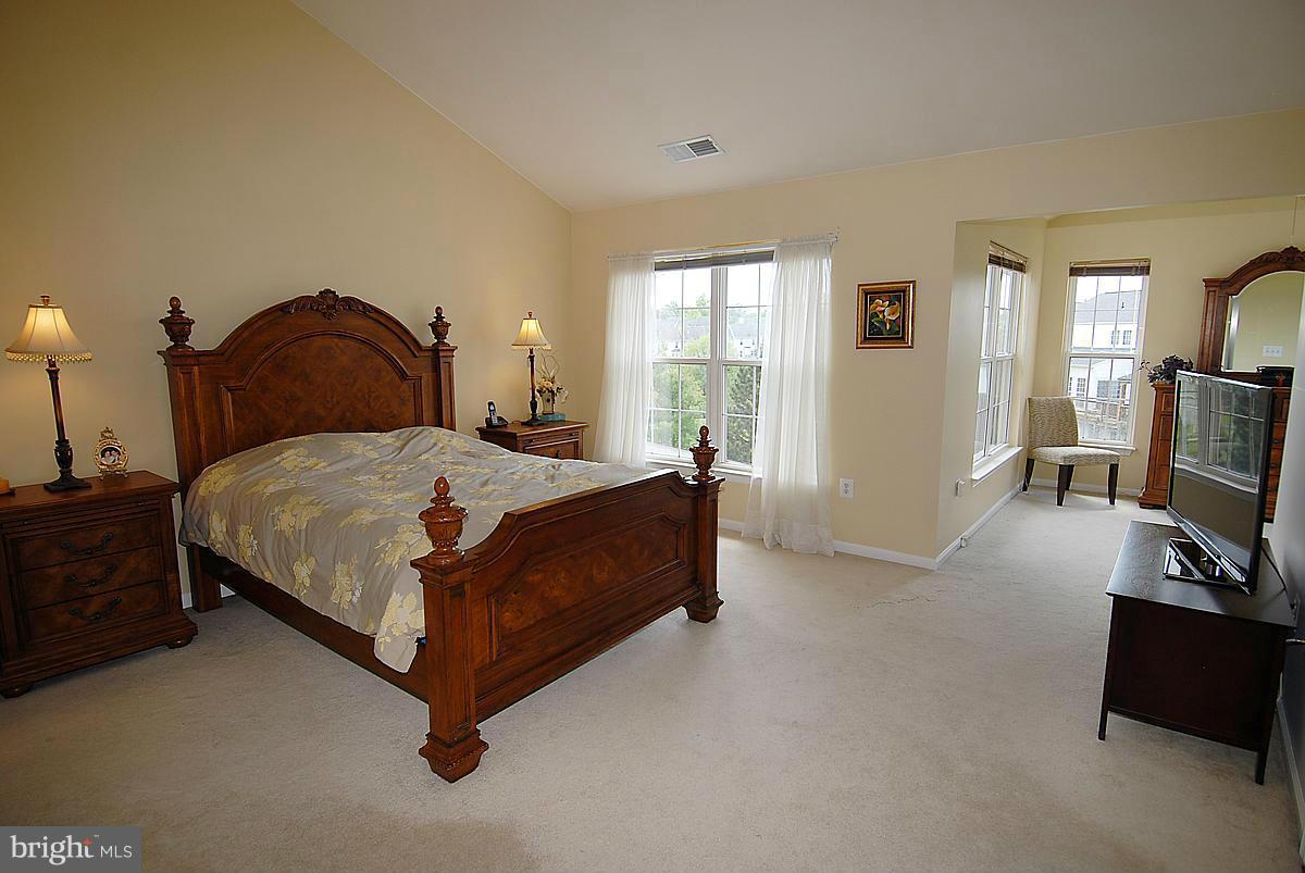 44047 Rising Sun Terrace Ashburn, VA 20147 - Photo 19 of 30 a bedroom with a bed flat screen tv and window