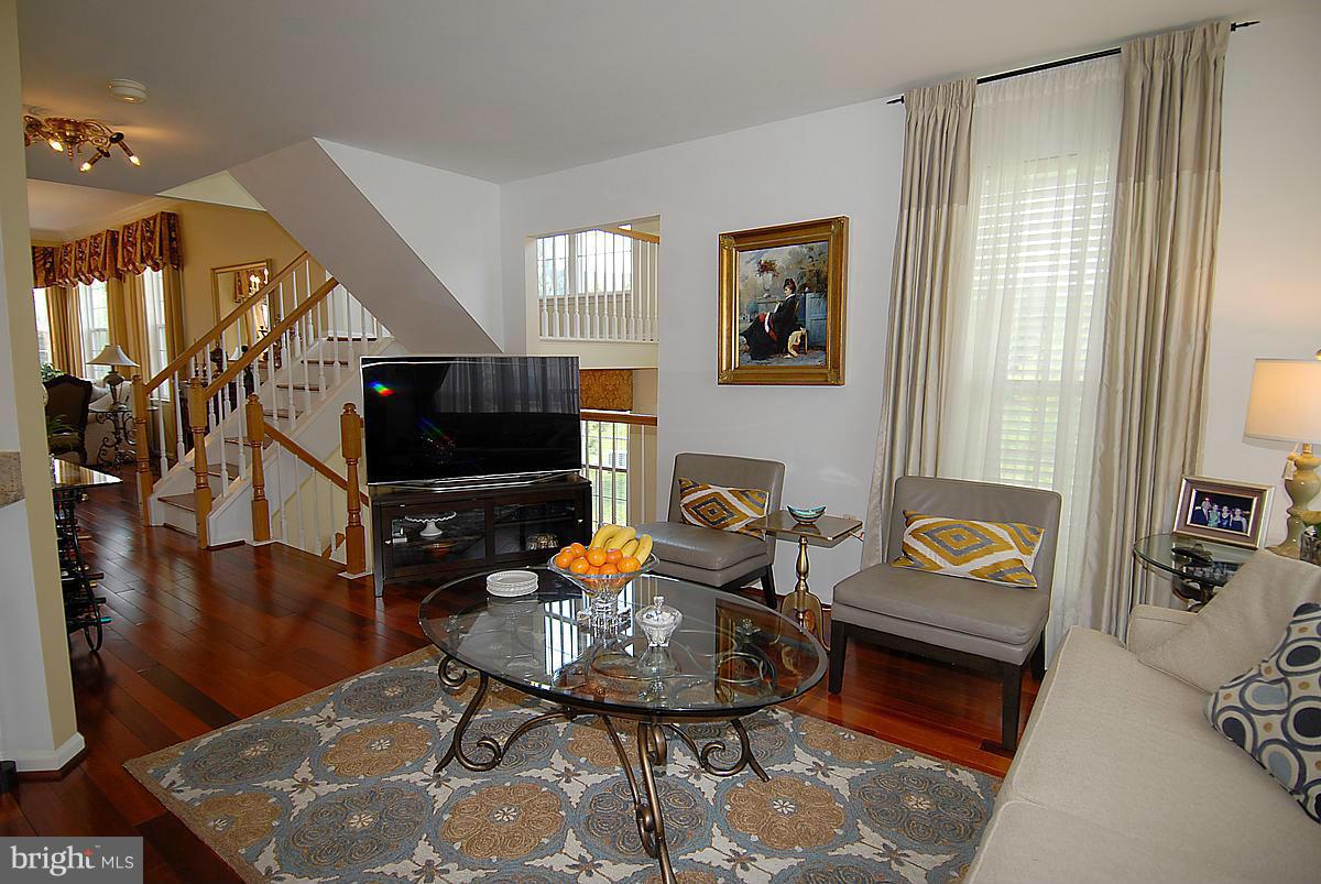 44047 Rising Sun Terrace Ashburn, VA 20147 - Photo 3 of 30 a living room with furniture and wooden floor