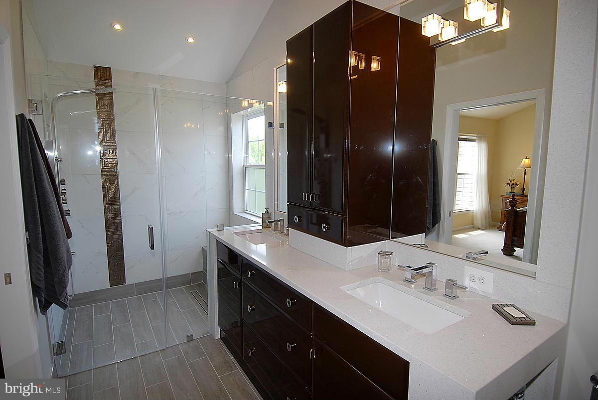 44047 Rising Sun Terrace Ashburn, VA 20147 - Photo 21 of 30 a bathroom with double vanity and a mirror