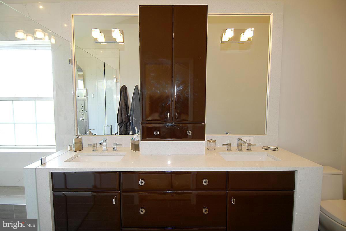 44047 Rising Sun Terrace Ashburn, VA 20147 - Photo 23 of 30 a bathroom with a sink and a mirror