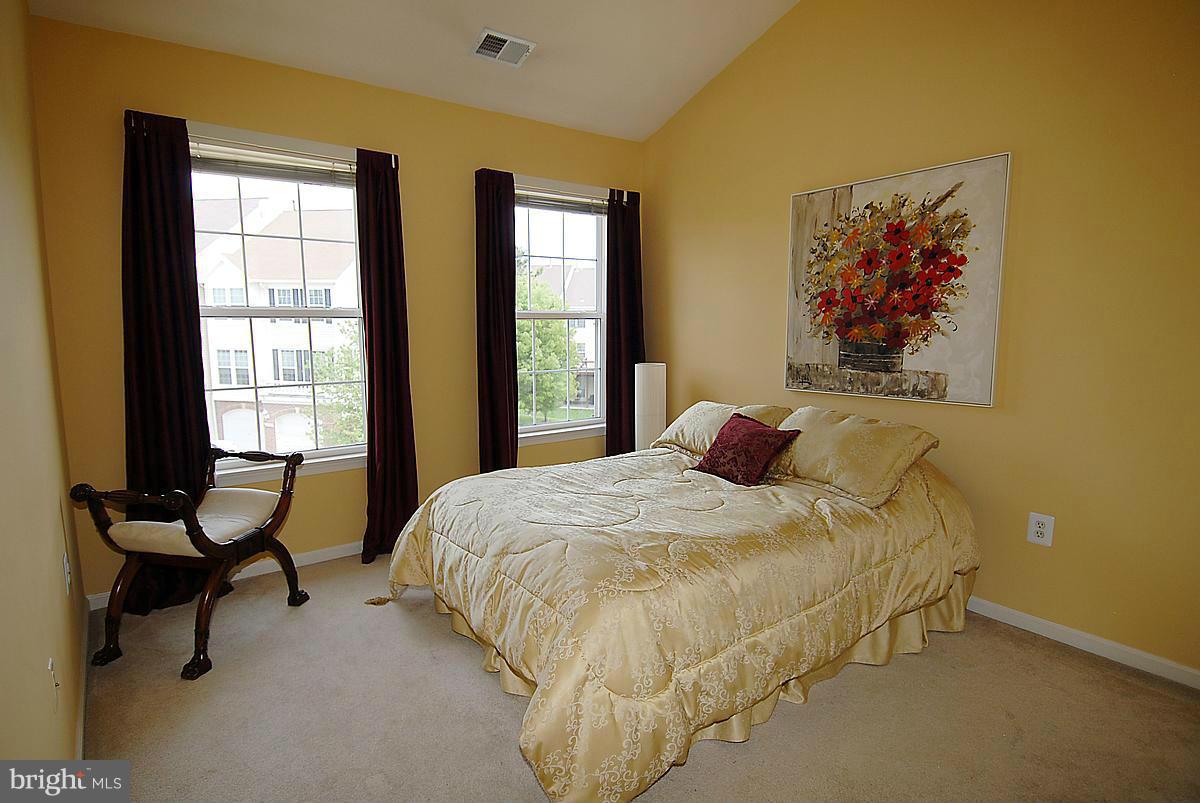 44047 Rising Sun Terrace Ashburn, VA 20147 - Photo 25 of 30 a bed sitting in a bedroom next to a window