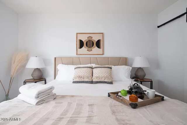 a bedroom with a bed and lamp