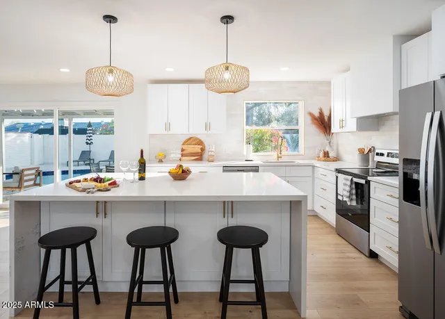 a kitchen with appliances cabinets and a counter top space