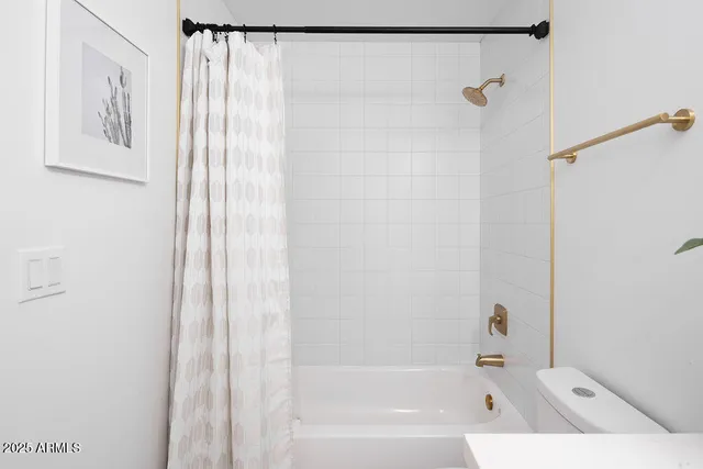 a bathroom with a bathtub and shower