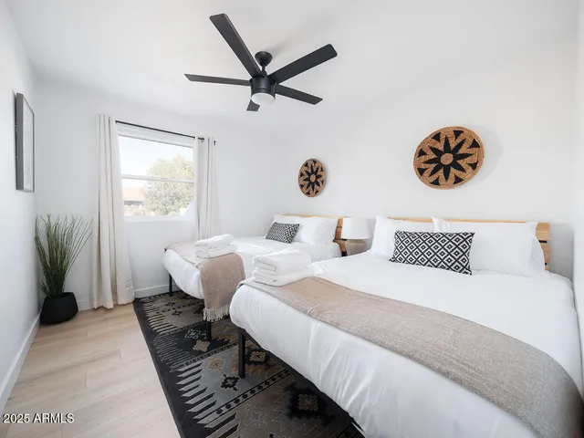 a bedroom with two beds and a window