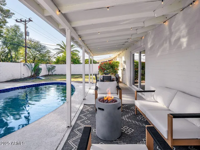 a view of a balcony with dining table and chairs with wooden floor