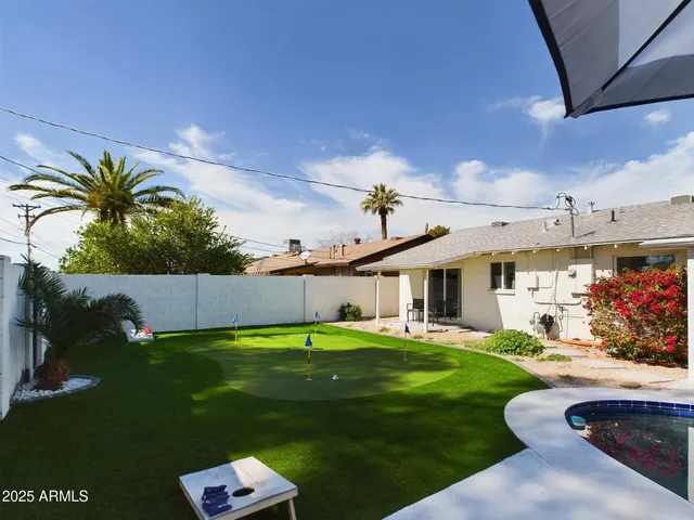 a swimming pool view with a garden space