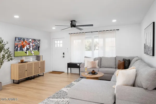a living room with furniture and a flat screen tv