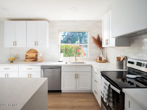 a kitchen with a sink stove and cabinets