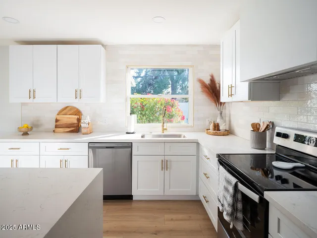 a kitchen with a sink stove and cabinets