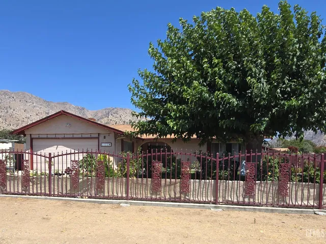 a view of a house with a wooden fence
