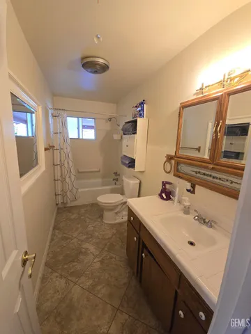 a bathroom with a sink toilet and mirror
